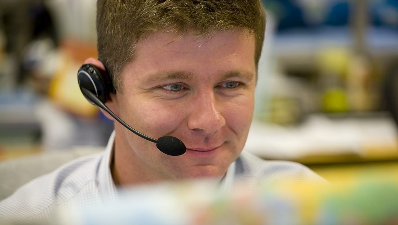 Man wearing headphone with mic answering calls