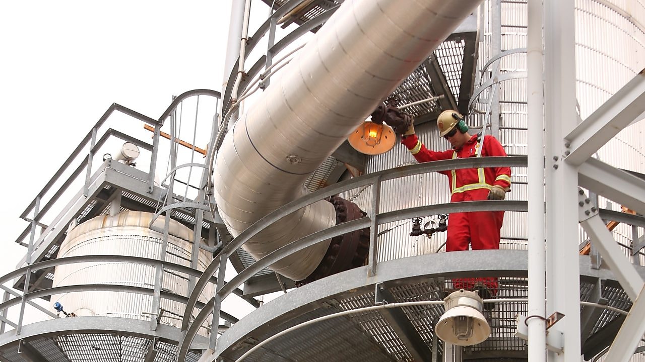 two shell employees working on shell equipment