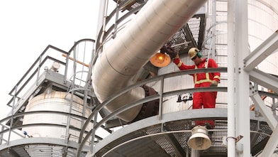 two shell employees working on shell equipment
