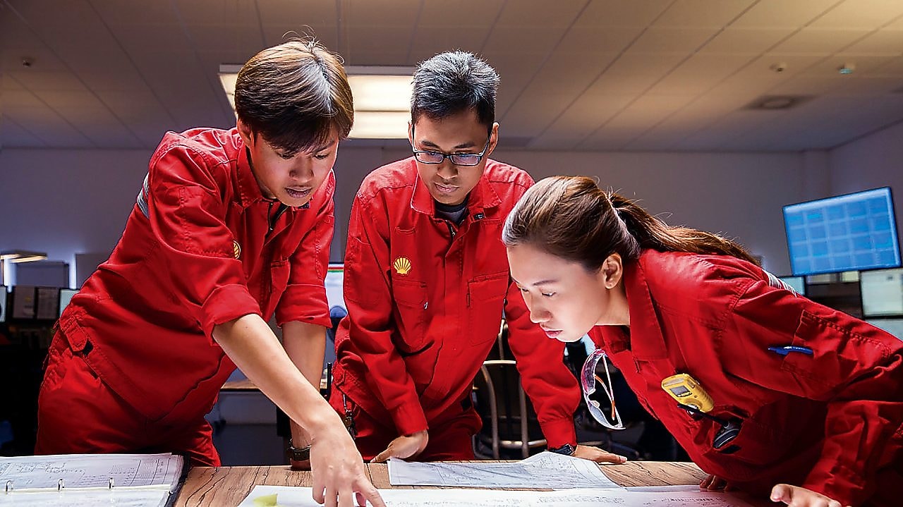 shell employees discussing plans with each other