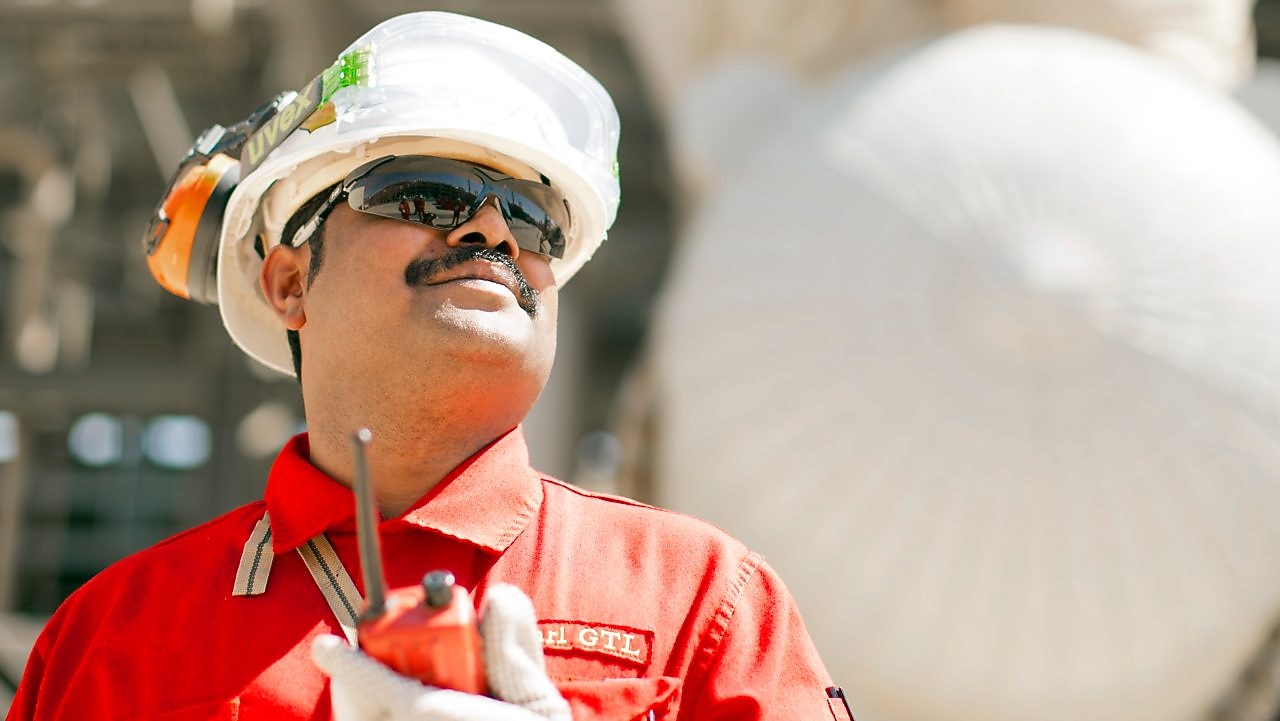 Shell employee uses a radio to communicate with coworkers.