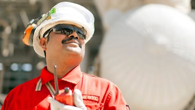Shell employee uses a radio to communicate with coworkers.