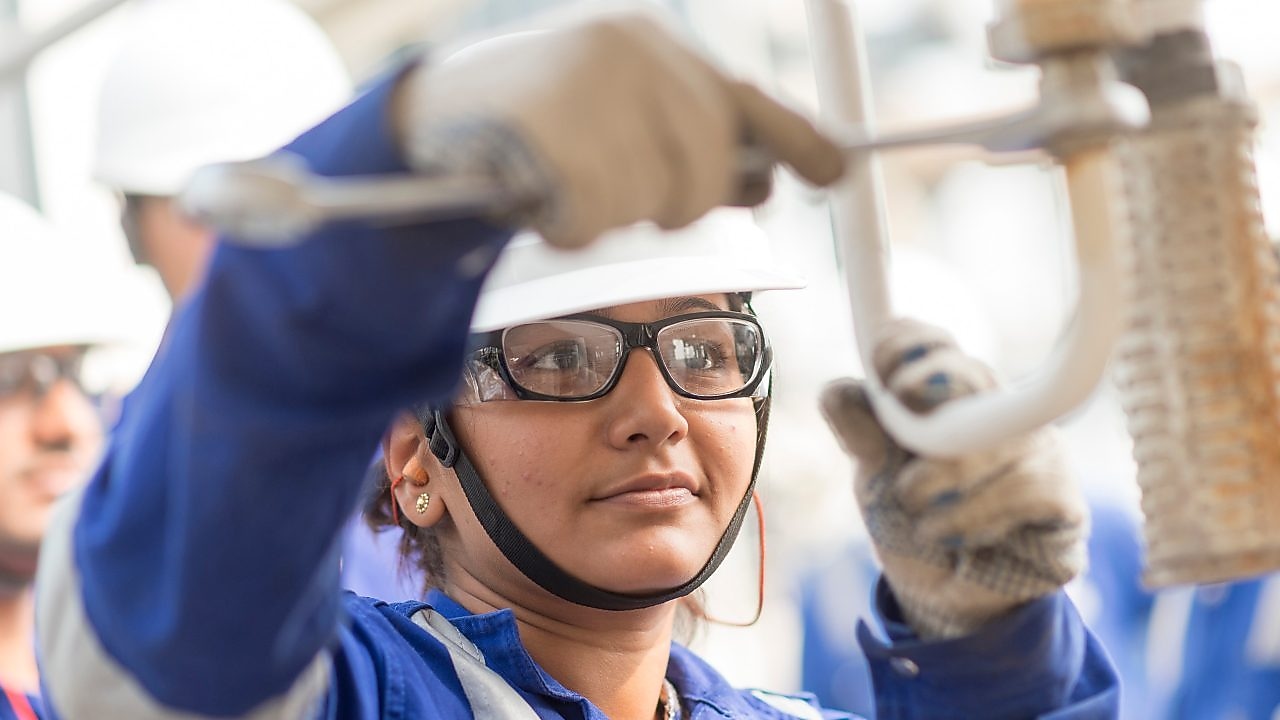 Shell employee working on refinery equipment