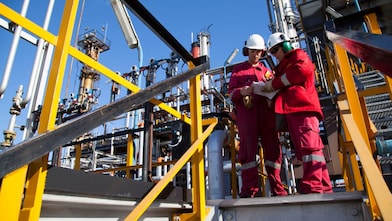 Two workers discuss catalysts reactions at Shell Argentina refinery