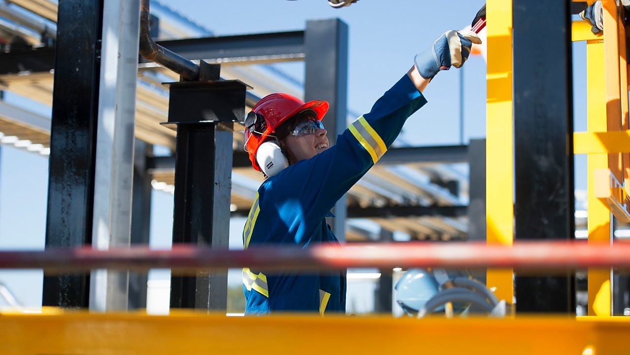 Workers walk toward a drill rig while staving off N2O Abatement