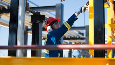 Workers walk toward a drill rig while staving off N2O Abatement