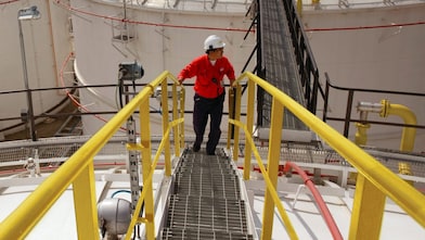 Shell worker turns valve while facilitating dioxin removal.