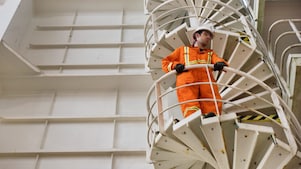 Worker watches from the stairs.