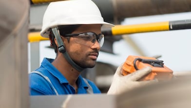 Employee conducts inspection at LNG tank used for aromatic saturation