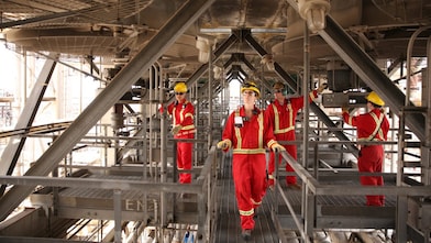 Employee conducts inspection at LNG tank used for aromatic saturation