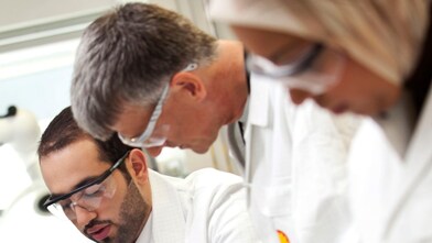 Three Shell scientists work together on ethlyene oxide catalysts in a laboratory.