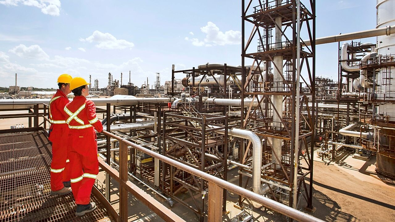 Workers survey a portion of the Quest unit at the Scotford