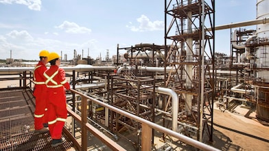 Workers survey a portion of the Quest unit at the Scotford