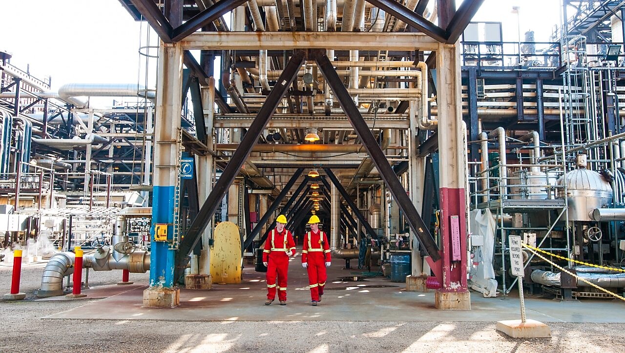 Two Shell Scotford employees walk out of the Sulphur Recovery Complex