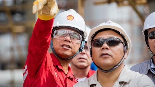 Employees reviewing LNG technology