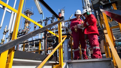 Two workers discuss catalysts reactions at Shell Argentina refinery