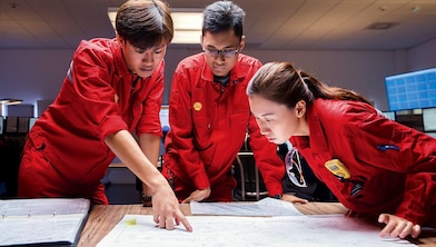 Shell employees discussing plans with each other
