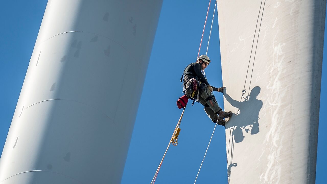 风力涡轮机维修人员正在高空作业。
