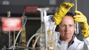 戴着护目镜正在实验室内进行实验的女士