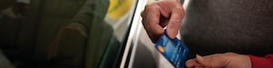 Man holding Shell card at Retail site