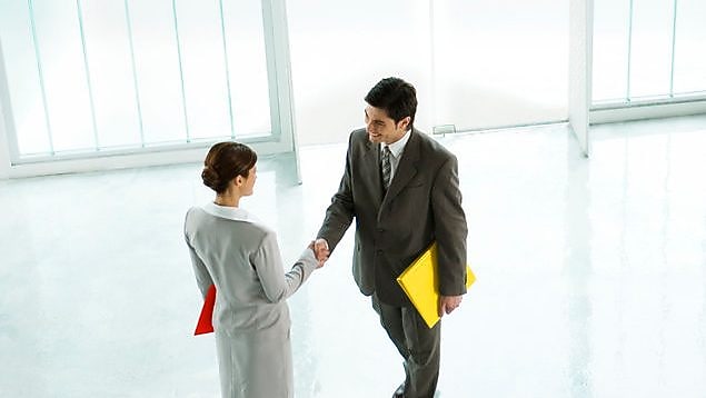 business people shaking hands at work area