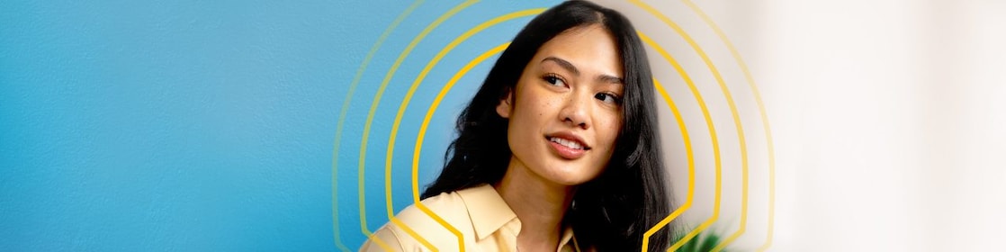 a female employee holding an ipad and looking somewhere with a smile