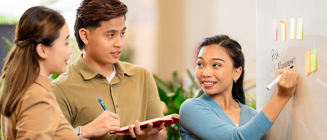 a female employee holding an ipad and looking somewhere with a smile