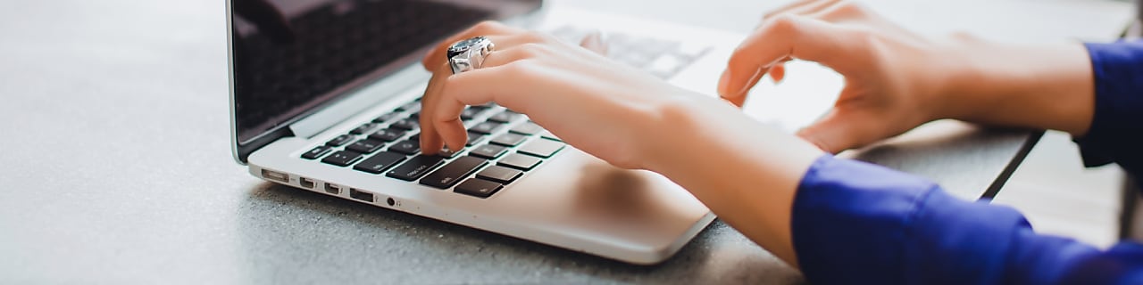 rear view of four business executives using computers in an office