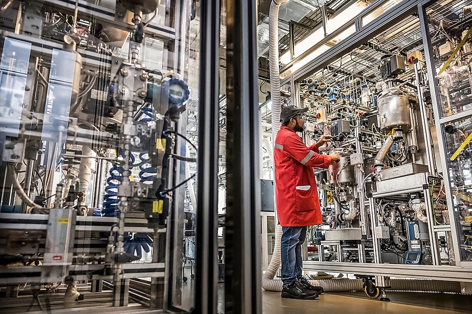 A worker monitors results of guard beds in a hydrogen plant