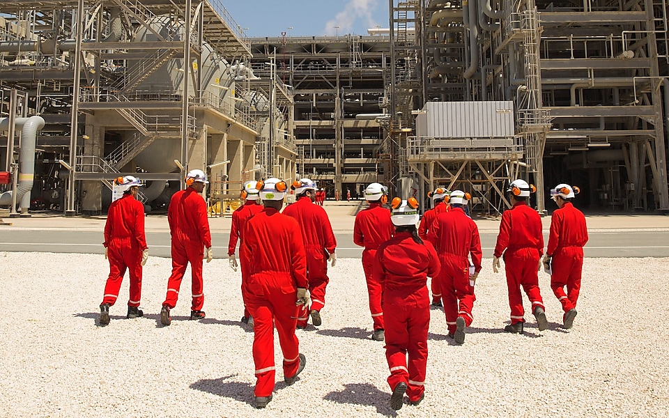 Amine gas treating engineers walk towards the Pre-treatment section of the gas-to-liquids area