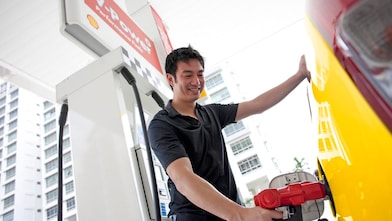 在加油泵前补充燃油的司机