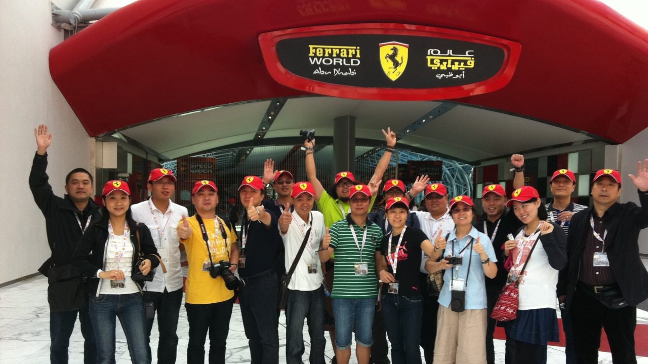 Group of people pose for picture and waving hands