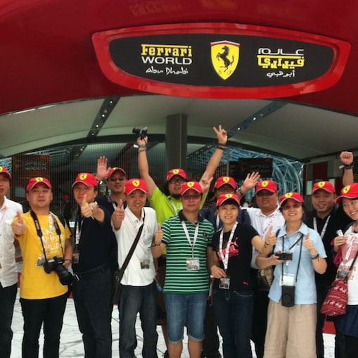 Group of people pose for picture and waving hands