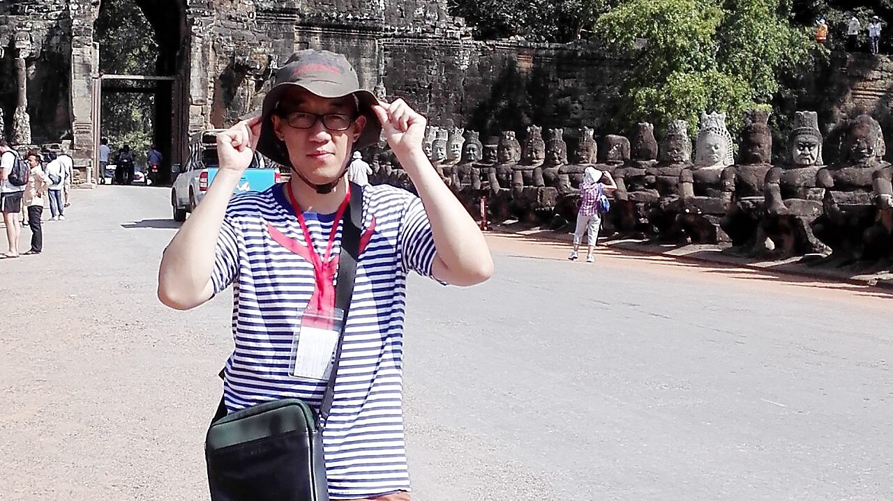 Han Bing Standing in front of Caves