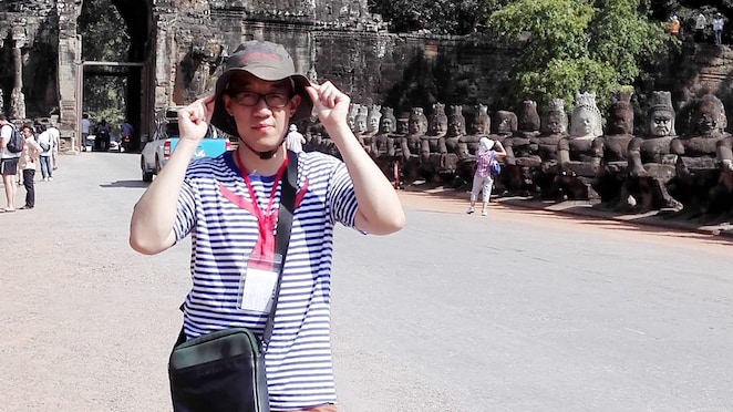 Han Bing Standing in front of Caves
