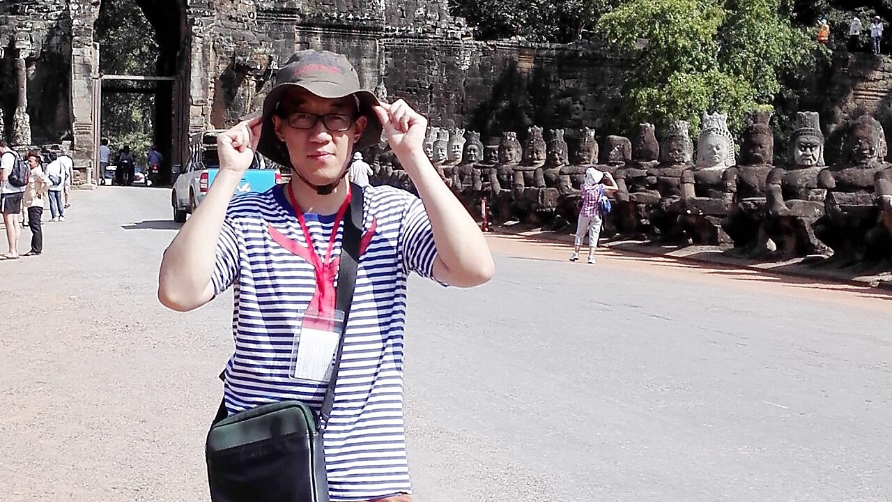 Han Bing posing in front of caves