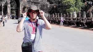 Han Bing posing in front of caves