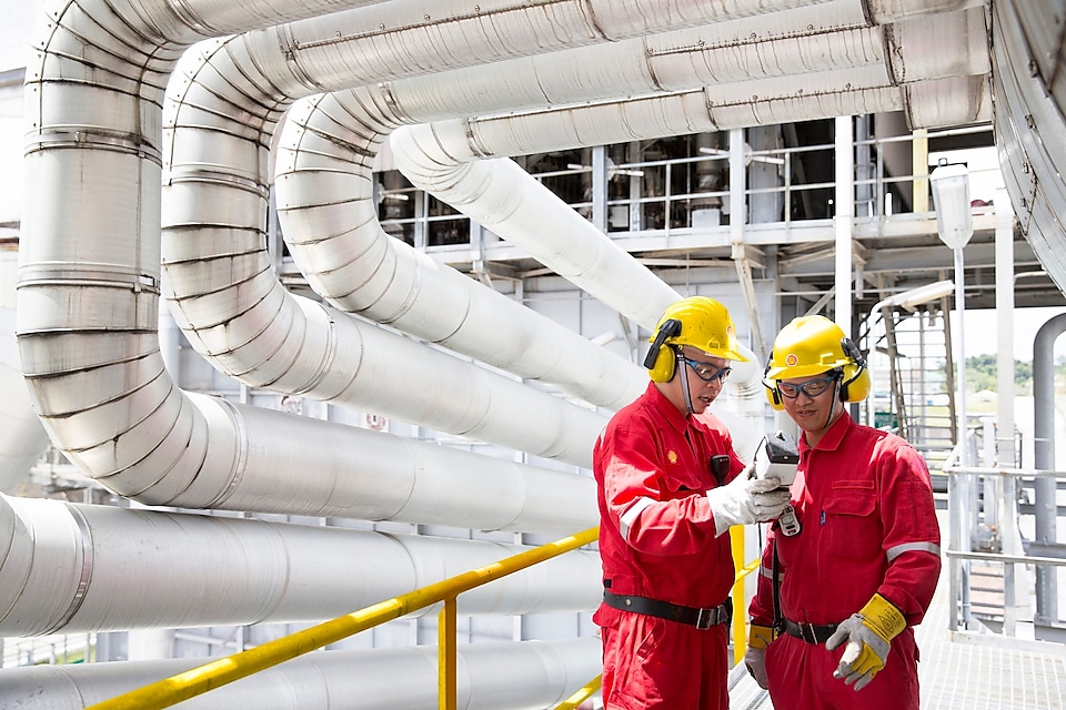 Employees meeting at the Groundbirch asset discussing tail gas treatment operations