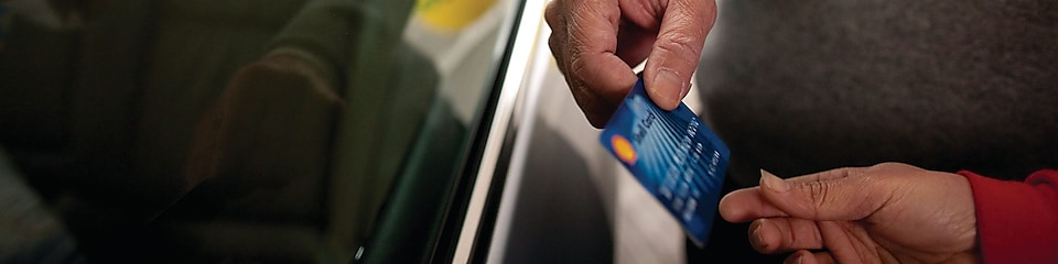 Man holding Shell card at Retail site